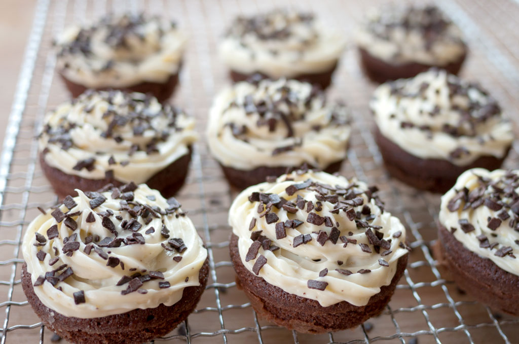 Cupcakes af chokoladedej, men hvid chokolade smørcreme og drys med chokoflager